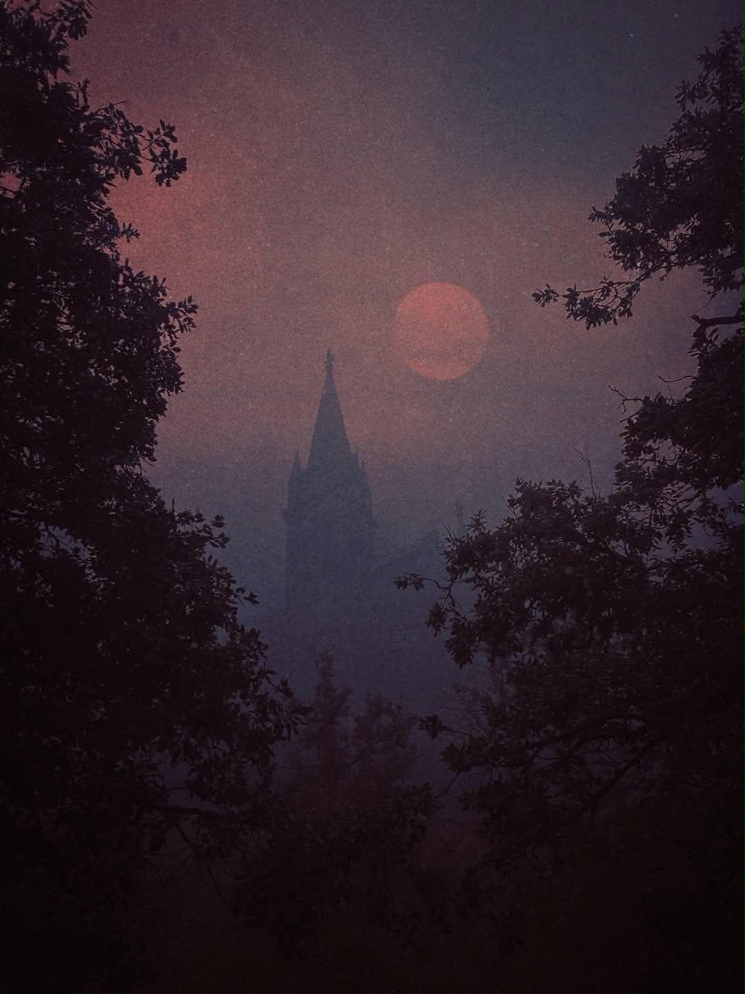 A church spire in fog under a blood moon, the mood of Fallen Angel Tattoo in Portland, Oregon